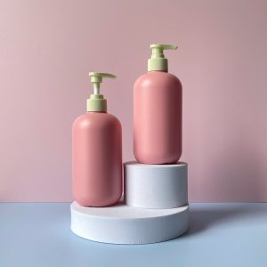 Chai nhựa HDPE hồng tròn với vòi nhấn sóng xanh nhạt sọc